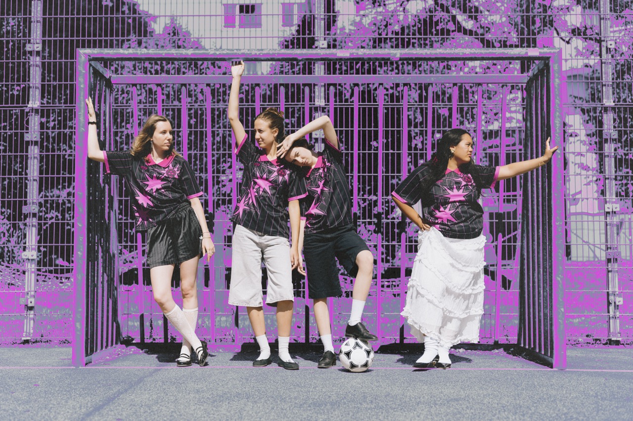 Models leaning on goal post